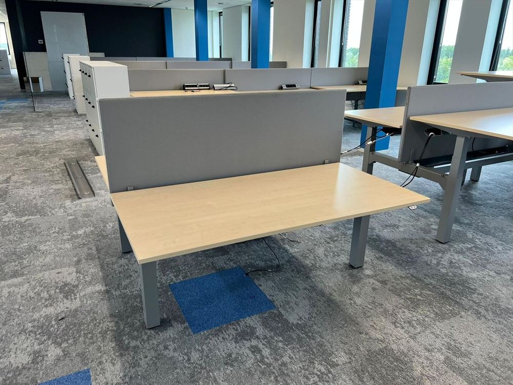 A single sit-stand desk with acoustic screen in place